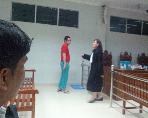 Terdakwa judi online W88 , Frangky memekai kaos tahanan berdiri usai menjalani sidang di PN Batam , pada Selasa (24/1/2017). foto (potretkepri.com)