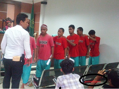 Terdakwa pembunuhan Ketua RT Tiban Lama , Syahrial,berjalan berjejer setelah usai mengikuti sidang di PN Batam . para terdakwa dituntut berbeda dari antara 6 tahun penjara hingga 13 tahun penjara. foto (potretkepri.com)